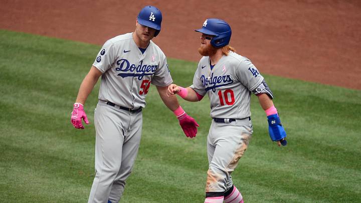 May 9, 2021; Anaheim, California, USA; Los Angeles Dodgers designated hitter Justin Turner (10) is greeted by third baseman Sheldon Neuse (56) after scoring a run against the Los Angeles Angels during the third inning at Angel Stadium. Mandatory Credit: Gary A. Vasquez-Imagn Images