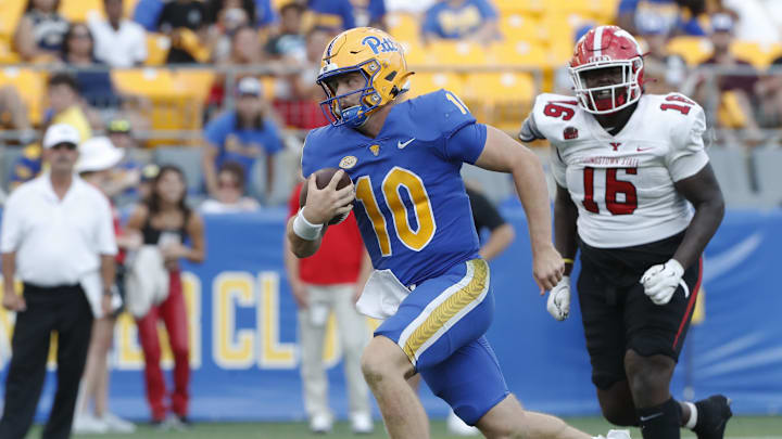 Sep 21, 2024; Pittsburgh, Pennsylvania, USA;  Pittsburgh Panthers quarterback Eli Holstein (10) runs with the ball against Youngstown State Penguins defensive lineman Jabarrek Hopkins (16)  during the third quarter at Acrisure Stadium. Mandatory Credit: Charles LeClaire-Imagn Images