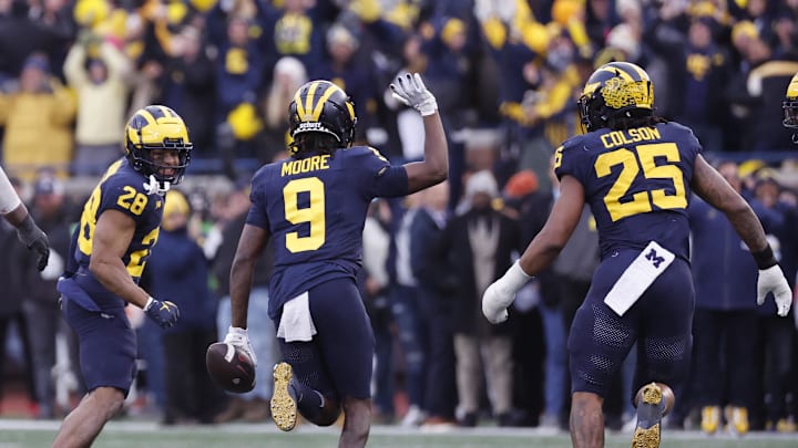 Nov 25, 2023; Ann Arbor, Michigan, USA; Michigan Wolverines defensive back Rod Moore (9) celebrates after he makes an interception in the second half against the Ohio State Buckeyes at Michigan Stadium. Mandatory Credit: Rick Osentoski-Imagn Images