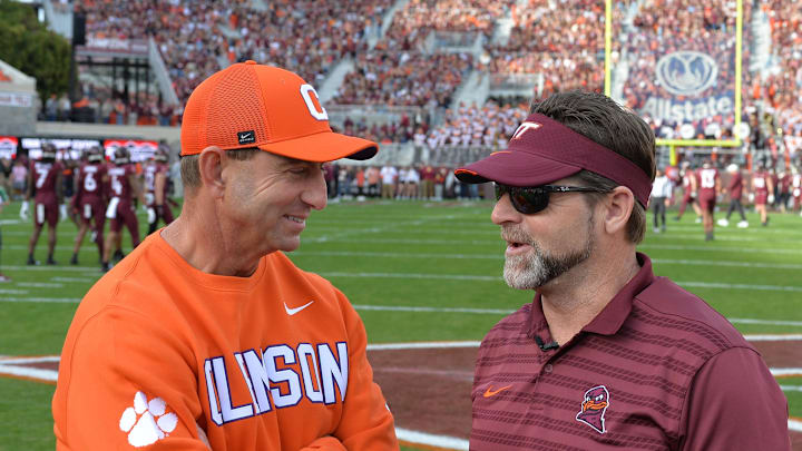 Nov 9, 2024; Blacksburg, Virginia, USA;  Virginia Tech Hokies head coach Brent Pry and Clemson Tigers head coach Dabo Swinney talk before the game at Lane Stadium. Mandatory Credit: Brian Bishop-Imagn Images
