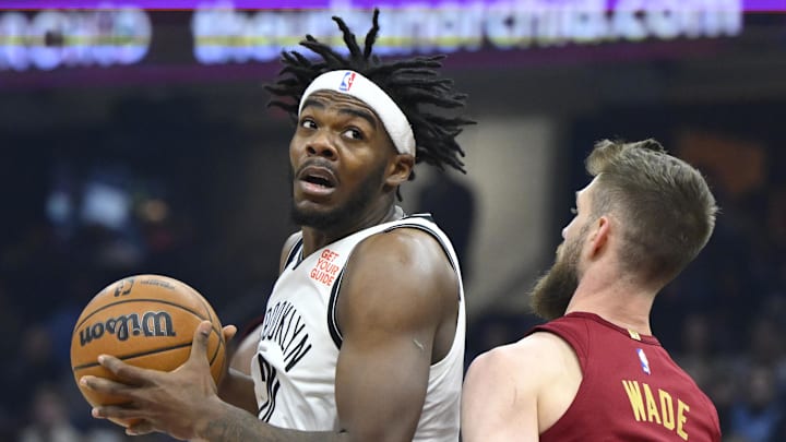 Mar 11, 2025; Cleveland, Ohio, USA; Brooklyn Nets center Day'Ron Sharpe (20) turns to the basket beside Cleveland Cavaliers forward Dean Wade (32) in the first quarter at Rocket Arena. Mandatory Credit: David Richard-Imagn Images