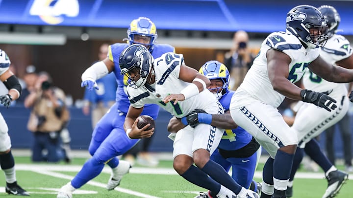 Jan 5, 2025; Inglewood, California, USA;  Los Angeles Rams defensive end Desjuan Johnson (94) sacks Seattle Seahawks Quarterback Geno Smith (7) at SoFi Stadium. Mandatory Credit: William Navarro-Imagn Images