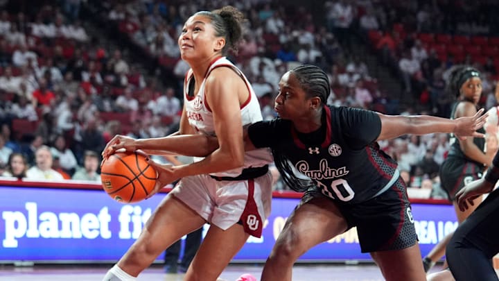 Oklahoma's Keziah Lofton (22) drives to the basket as South Carolina 's Ta'niya Latson (00) defends of the women's college basketball game between the Oklahoma Sooners and South Carolina at the Lloyd Noble Center in Norman, Okla., Thursday Jan. 22, 2026.