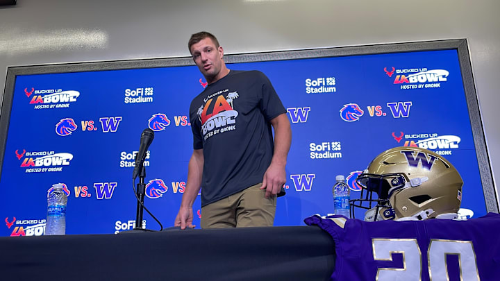 Rob Gronkowski is about to stumble and nearly take a header over the table. Rob Gronkowski is about to stumble and nearly take a header over the table.