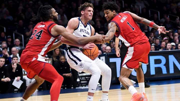 Jan 6, 2026; Indianapolis, Indiana, USA; Butler Bulldogs guard Jamie Kaiser Jr. (7) goes to the basket against St. John's basketball forward Zuby Ejiofor (24) and St. John's Red Storm forward Dillon Mitchell (1) during the second half at Hinkle Fieldhouse.