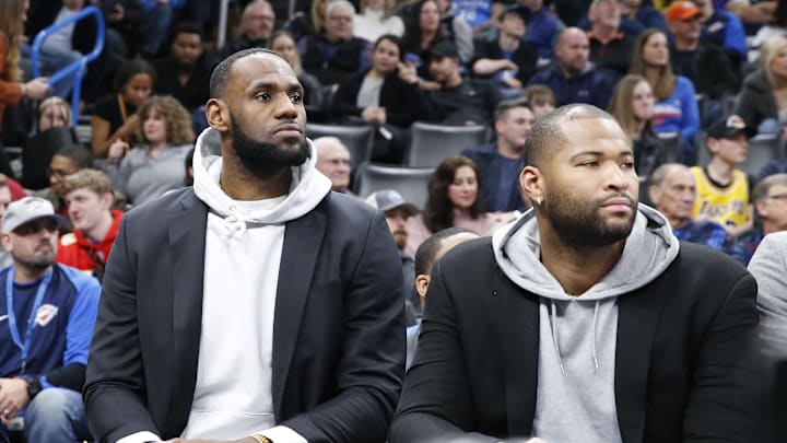 Los Angeles Lakers forward LeBron James and center DeMarcus Cousins on the bench against the Oklahoma City Thunder.