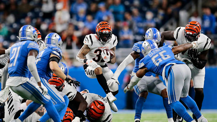 Cincinnati Bengals running back Trayveon Williams (32) leaps over the pile as he runs the ball in