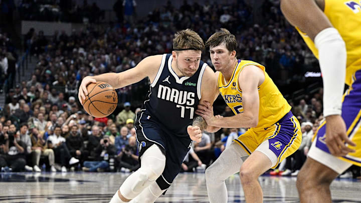 Dec 12, 2023; Dallas, Texas, USA; Dallas Mavericks guard Luka Doncic (77) and Los Angeles Lakers guard Austin Reaves (15) in action during the game between the Dallas Mavericks and the Los Angeles Lakers at the American Airlines Center. Mandatory Credit: Jerome Miron-Imagn Images