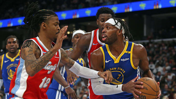 Apr 1, 2025; Memphis, Tennessee, USA; Golden State Warriors guard Buddy Hield (7) drives to the basket as Memphis Grizzlies guard Ja Morant (12) defends during the third quarter at FedExForum. Mandatory Credit: Petre Thomas-Imagn Images