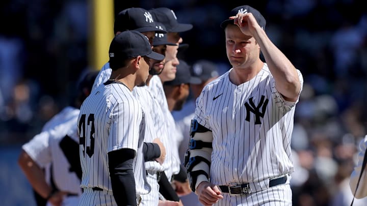 Mar 27, 2025; Bronx, New York, USA; New York Yankees injured starting pitcher Gerrit Cole (45) tips his cap towards the Milwaukee Brewers base line during introductions before an opening day game at Yankee Stadium. Mandatory Credit: Brad Penner-Imagn Images