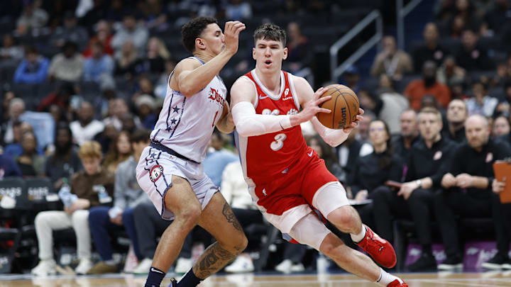 Dec 8, 2024; Washington, District of Columbia, USA; Memphis Grizzlies forward Jake LaRavia (3) drives to the basket and Washington Wizards guard Johnny Davis (1) defends in the fourth quarter at Capital One Arena. Mandatory Credit: Geoff Burke-Imagn Images