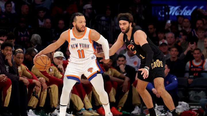New York Knicks guard Jalen Brunson controls the ball against Cleveland Cavaliers guard Max Strus. Mandatory Credit: Brad Penner-Imagn Images