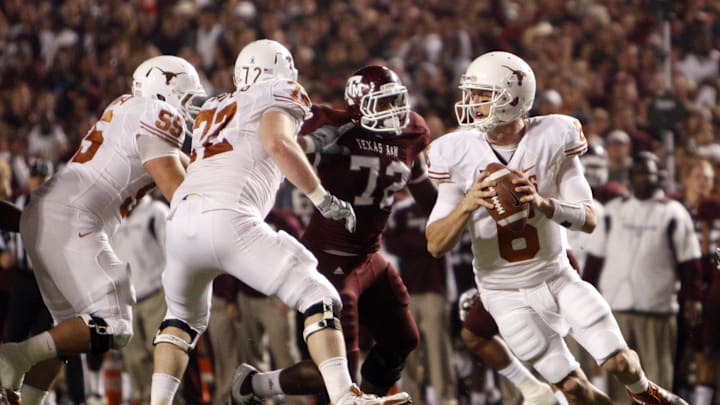 Nov 24, 2011; College Station, TX, USA; Texas Longhorns quarterback Case McCoy (6) rolls out away from Texas A&M Aggies defensive lineman Gavin Stansbury (72) during the first quarter at Kyle Field. Mandatory Credit: Thomas Campbell-US Presswire