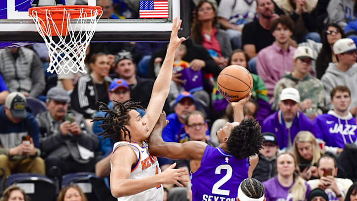 Nov 23, 2024; Salt Lake City, Utah, USA; Utah Jazz guard Collin Sexton (2) shoots the ball over New York Knicks forward Pacome Dadiet (4) during the first half at the Delta Center. Mandatory Credit: Christopher Creveling-Imagn Images