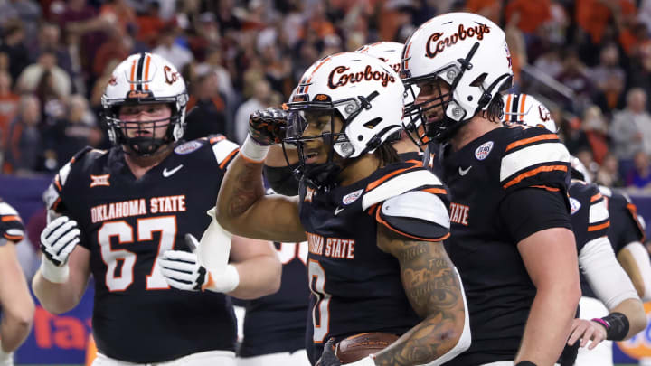 Dec 27, 2023; Houston, TX, USA; Oklahoma State Cowboys running back Ollie Gordon II (0) celebrates his rushing touchdown with teammates against the Texas A&M Aggies in the second quarter at NRG Stadium. Mandatory Credit: Thomas Shea-USA TODAY Sports Dec 27, 2023; Houston, TX, USA; Oklahoma State Cowboys running back Ollie Gordon II (0) celebrates his rushing touchdown with teammates against the Texas A&M Aggies in the second quarter at NRG Stadium. Mandatory Credit: Thomas Shea-USA TODAY Sports