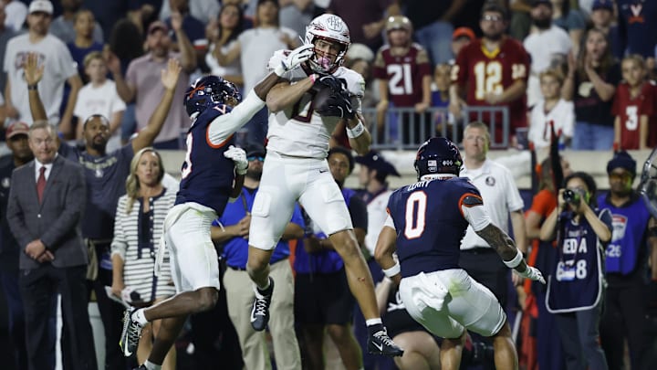Sep 26, 2025; Charlottesville, Virginia, USA; Florida State Seminoles wide receiver Duce Robinson (0) catches a pass as Virginia Cavaliers cornerback Emmanuel Karnley (19) and Cavaliers safety Antonio Clary (0) defend during the second quarter at Scott Stadium. Mandatory Credit: Geoff Burke-Imagn Images