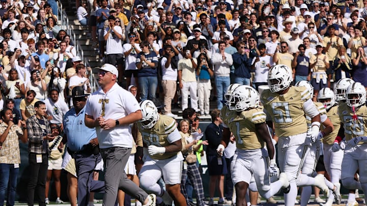 Oct 25, 2025; Atlanta, Georgia, USA; Georgia Tech Yellow Jackets head coach Brent Key runs with his team on the field before a game against the Syracuse Orange at Bobby Dodd Stadium at Hyundai Field. Mandatory Credit: Brett Davis-Imagn Images
