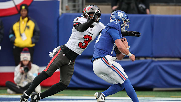 Nov 24, 2024; East Rutherford, New Jersey, USA; New York Giants quarterback Tommy DeVito (15) is tackled by Tampa Bay Buccaneers safety Jordan Whitehead (3) during the second half at MetLife Stadium. Mandatory Credit: Vincent Carchietta-Imagn Images