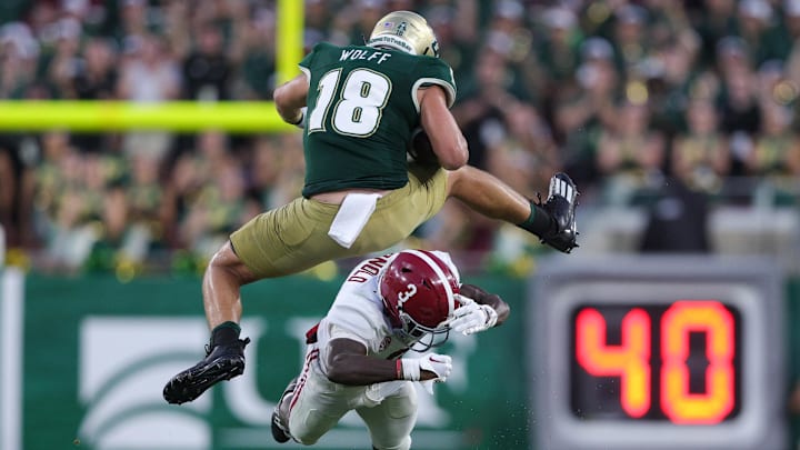 Sep 16, 2023; Tampa, Florida, USA;  South Florida Bulls tight end Weston Wolff (18) leaps over Alabama Crimson Tide defensive back Terrion Arnold (3) in the fourth quarter at Raymond James Stadium. Mandatory Credit: Nathan Ray Seebeck-USA TODAY Sports