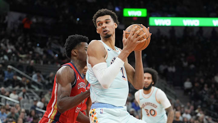 Dec 8, 2024; San Antonio, Texas, USA;  San Antonio Spurs center Victor Wembanyama (1) controls the ball against New Orleans Pelicans center Yves Missi (21) in the second half at Frost Bank Center. Mandatory Credit: Daniel Dunn-Imagn Images