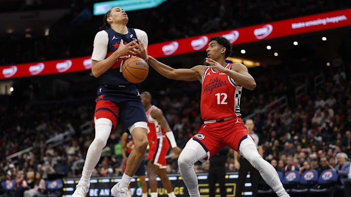 Jan 19, 2026; Washington, District of Columbia, USA; LA Clippers guard Cam Christie (12) knocks the ball from Washington Wizards forward Kyshawn George (18) in the first half at Capital One Arena. Mandatory Credit: Geoff Burke-Imagn Images