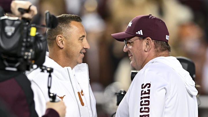 Nov 30, 2024; College Station, Texas, USA; Texas Longhorns head coach Steve Sarkisian, left, and Texas A&M Aggies head coach Mike Elko, right, speak prior to the game at Kyle Field. Mandatory Credit: Maria Lysaker-Imagn Images Nov 30, 2024; College Station, Texas, USA; Texas Longhorns head coach Steve Sarkisian, left, and Texas A&M Aggies head coach Mike Elko, right, speak prior to the game at Kyle Field. Mandatory Credit: Maria Lysaker-Imagn Images