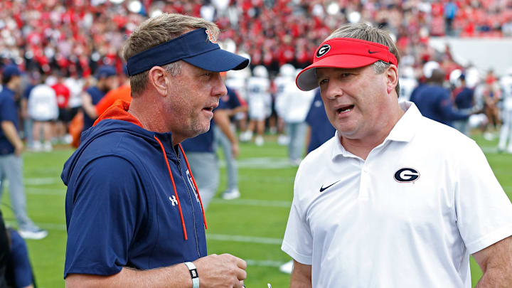 Auburn head coach Hugh Freeze speaks with Georgia head coach Kirby Smart.