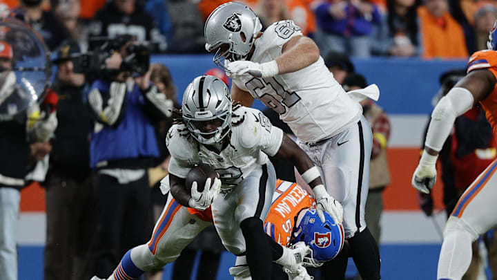 Nov 6, 2025; Denver, Colorado, USA; Las Vegas Raiders running back Ashton Jeanty (2) rushes the ball against the Denver Broncos during the second half at Empower Field at Mile High. Mandatory Credit: Isaiah J. Downing-Imagn Images