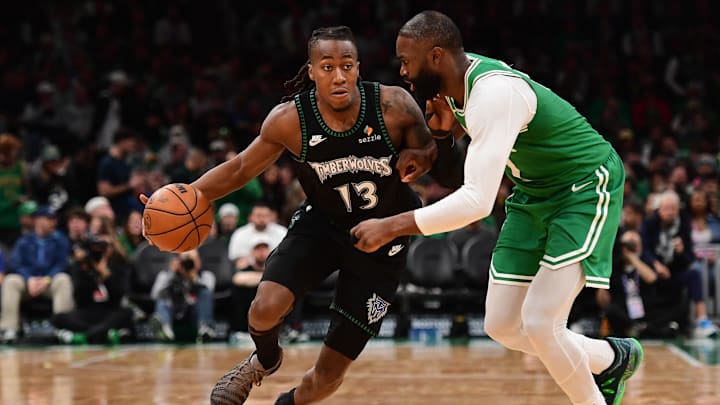 Mar 22, 2026; Boston, Massachusetts, USA;  Minnesota Timberwolves guard Ayo Dosunmu (13) controls the ball while Boston Celtics guard Jaylen Brown (7) defends during the second half at TD Garden. Mandatory Credit: Bob DeChiara-Imagn Images