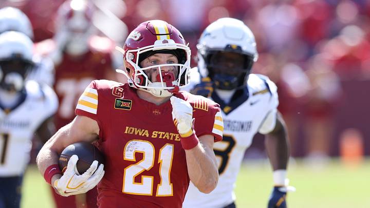 Oct 3, 2026; Ames, Iowa, USA; Iowa State Cyclones running back Aiden Flora (21) breaks through the West Virginia Mountaineers defense for a touchdown during the second half at Jack Trice Stadium. Mandatory Credit: Reese Strickland-Imagn Images Oct 3, 2026; Ames, Iowa, USA; Iowa State Cyclones running back Aiden Flora (21) breaks through the West Virginia Mountaineers defense for a touchdown during the second half at Jack Trice Stadium. Mandatory Credit: Reese Strickland-Imagn Images