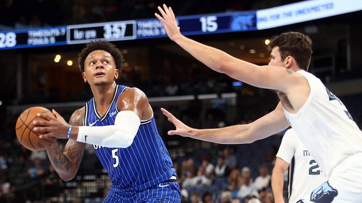 Oct 7, 2026; Memphis, Tennessee, USA;  Orlando Magic forward Paolo Banchero (5) handles the ball as Memphis Grizzlies center Quinten Post (41) defends during the second quarter at FedExForum.  Mandatory Credit: Petre Thomas-Imagn Images