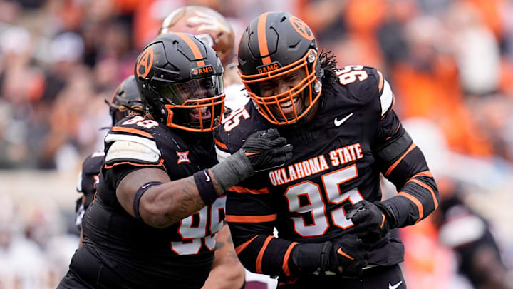 Oklahoma State Cowboys defensive end Jaleel Johnson (95) celebrates his sack with Iman Oates (99) in the first half the college football game between the Oklahoma State Cowboys and the Arizona State Sun Devils at Boone Pickens Stadium in Stillwater, Okla., Saturday, Nov., 2, 2024.
