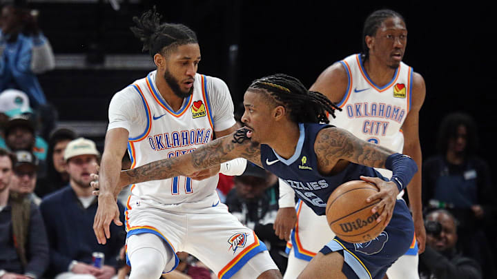 Mar 5, 2025; Memphis, Tennessee, USA; Memphis Grizzlies guard Ja Morant (12) drives to the basket as Oklahoma City Thunder guard Isaiah Joe (11) defends during the second quarter at FedExForum. Mandatory Credit: Petre Thomas-Imagn Images