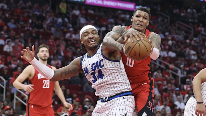 Nov 16, 2025; Houston, Texas, USA; Orlando Magic center Wendell Carter Jr. (34) and Houston Rockets forward Jabari Smith Jr. (10) battle for a ball during the second quarter at Toyota Center. Mandatory Credit: Troy Taormina-Imagn Images