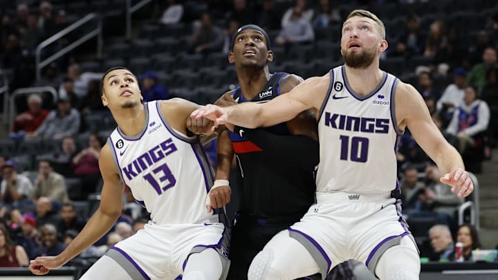 Dec 16, 2022; Detroit, Michigan, USA;  Sacramento Kings forward Keegan Murray (13) and forward Domantas Sabonis (10) box out Detroit Pistons center Jalen Duren (0) in the second half at Little Caesars Arena. Mandatory Credit: Rick Osentoski-Imagn Images