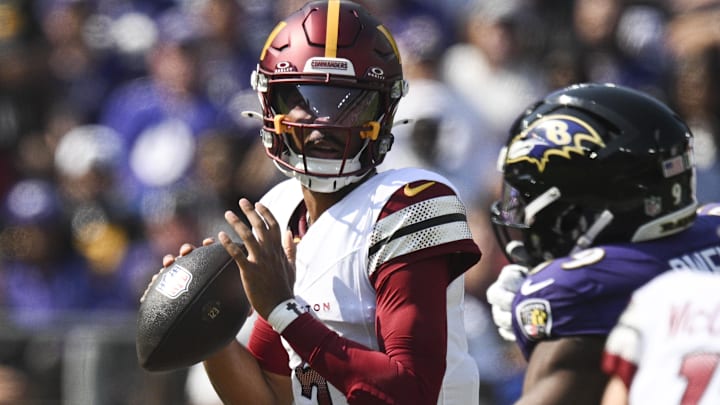 Oct 13, 2024; Baltimore, Maryland, USA;  Washington Commanders quarterback Jayden Daniels (5) loos to throws during the first quarter against the Baltimore Ravens at M&T Bank Stadium. Mandatory Credit: Tommy Gilligan-Imagn Images
