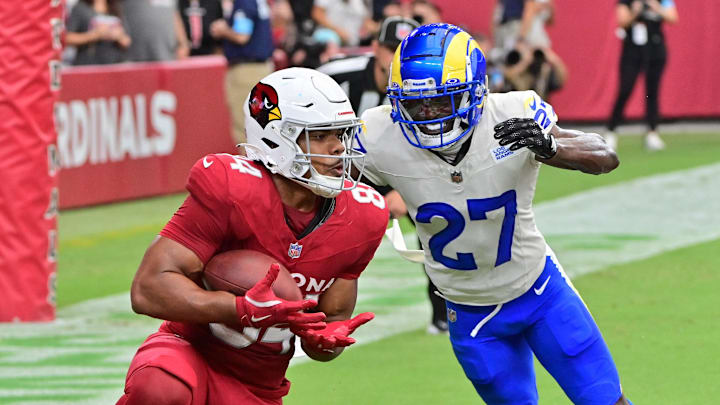 Sep 15, 2024; Glendale, Arizona, USA;  Arizona Cardinals tight end Elijah Higgins (84) catches a touchdown  as Los Angeles Rams cornerback Tre'Davious White (27) defends in the first half at State Farm Stadium. Mandatory Credit: Matt Kartozian-Imagn Images