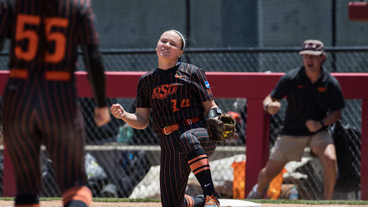 May 17, 2025; Fayetteville, AR, USA;  Oklahoma State Cowgirls infielder Karli Godwin (14) reacts to making a play at first for an out during the fourth inning against the Arkansas Lady Razorbacks.  Mandatory Credit: Brett Rojo-Imagn Images