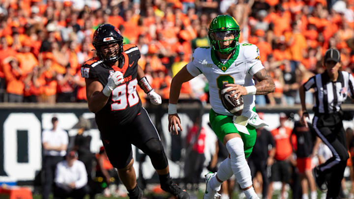 Oregon quarterback Dillon Gabriel breaks out under cover from Oregon State defensive lineman Thomas Collins as the Oregon State Beavers host the Oregon Ducks Saturday, Sept. 14, 2024 at Reser Stadium in Corvallis, Ore. Oregon quarterback Dillon Gabriel breaks out under cover from Oregon State defensive lineman Thomas Collins as the Oregon State Beavers host the Oregon Ducks Saturday, Sept. 14, 2024 at Reser Stadium in Corvallis, Ore.