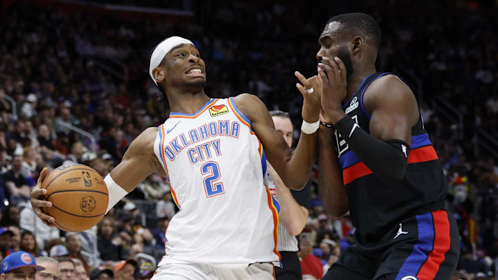 Mar 15, 2025; Detroit, Michigan, USA;  Oklahoma City Thunder guard Shai Gilgeous-Alexander (2) is defended by Detroit Pistons forward Tim Hardaway Jr. (8) in the second half at Little Caesars Arena. Mandatory Credit: Rick Osentoski-Imagn Images