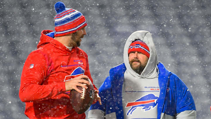 Dec 6, 2021; Orchard Park, New York, USA; Buffalo Bills quarterback Josh Allen (left) talks with offensive coordinator Brian Daboll (right) in a snow storm prior to the game against the New England Patriots at Highmark Stadium. Dec 6, 2021; Orchard Park, New York, USA; Buffalo Bills quarterback Josh Allen (left) talks with offensive coordinator Brian Daboll (right) in a snow storm prior to the game against the New England Patriots at Highmark Stadium.