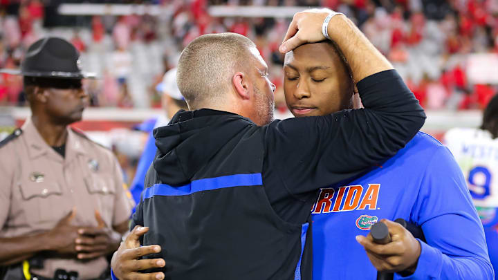 Florida Gators head coach Billy Napier gives an injured Florida Gators quarterback DJ Lagway (2) a hug after the game at EverBank Stadium in Jacksonville, FL on Saturday, November 2, 2024. The Bulldogs defeated the Gators 34-20. [Doug Engle/Gainesville Sun]