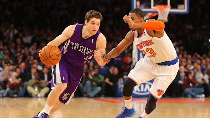 Feb 12, 2014; New York, NY, USA;  Sacramento Kings point guard Jimmer Fredette (7) brings the ball up court during the first half against New York Knicks shooting guard Toure' Murry (23) at Madison Square Garden. Mandatory Credit: Jim O'Connor-Imagn Images