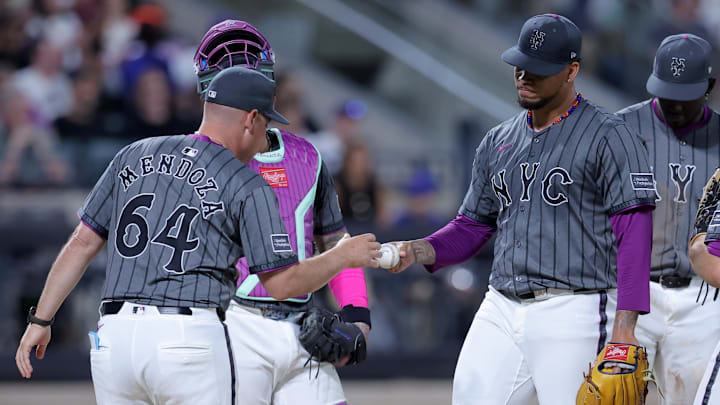Jul 22, 2025; New York City, New York, USA; New York Mets manager Carlos Mendoza (64) takes the ball from starting pitcher Frankie Montas (47) during a pitching change during the sixth inning against the Los Angeles Angels at Citi Field. Mandatory Credit: Brad Penner-Imagn Images