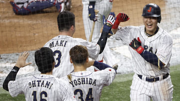Mar 21, 2023; Miami, Florida, USA; Japan first baseman Kazuma Okamoto (25) celebrates his home run against the USA in the fourth inning at LoanDepot Park. Mandatory Credit: Rhona Wise-Imagn Images