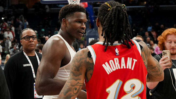 Timberwolves' Anthony Edwards (5) and Grizzlies' Ja Morant (12) hug after the Timberwolves defeated the Grizzlies 141-125 at FedExForum in Memphis, Tenn., on Thursday, April 10, 2025.