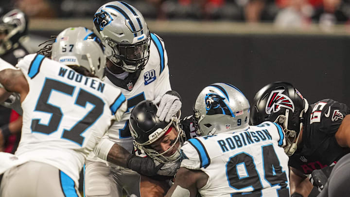Jan 5, 2025; Atlanta, Georgia, USA; Atlanta Falcons running back Tyler Allgeier (25) is tackled by Carolina Panthers linebacker Jadeveon Clowney (7) and defensive end A'Shawn Robinson (94) during the first quarter at Mercedes-Benz Stadium. Mandatory Credit: Dale Zanine-Imagn Images Jan 5, 2025; Atlanta, Georgia, USA; Atlanta Falcons running back Tyler Allgeier (25) is tackled by Carolina Panthers linebacker Jadeveon Clowney (7) and defensive end A'Shawn Robinson (94) during the first quarter at Mercedes-Benz Stadium. Mandatory Credit: Dale Zanine-Imagn Images