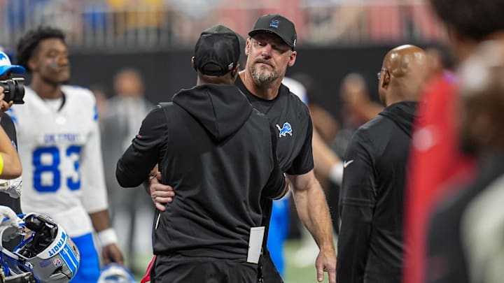 Aug 8, 2025; Atlanta, Georgia, USA; Detroit Lions head coach Dan Campbell and Atlanta Falcons head coach Raheem Morris react after the game was suspended after an injury to Lions safety Morice Norris (26) (not shown) during the game against the Atlanta Falcons at Mercedes-Benz Stadium. Mandatory Credit: Dale Zanine-Imagn Images