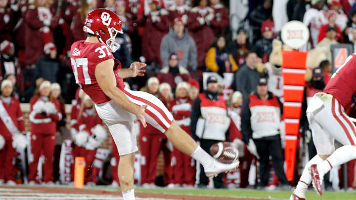 Oklahoma's Michael Turk (37) punts during a Bedlam college football game between the University of