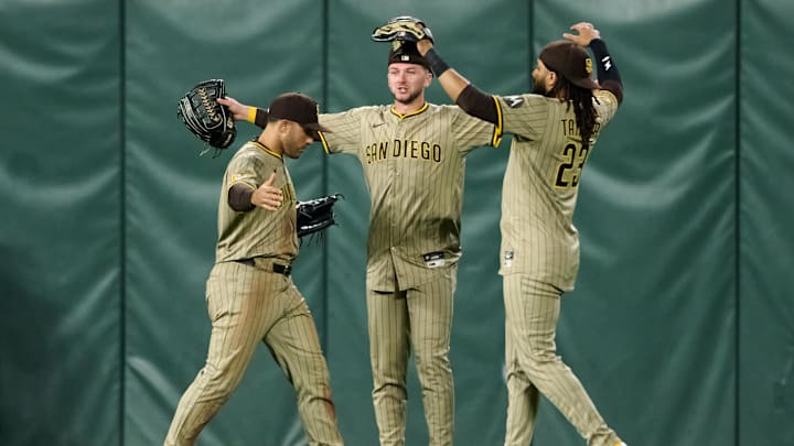 Aug 12, 2025; San Francisco, California, USA; San Diego Padres outfielders Ramon Laureano (5) (left), Jackson Merrill (3) (center) and Fernando Tatis Jr. (23) celebrate after defeating the San Francisco Giants in the ninth inning at Oracle Park. Mandatory Credit: Robert Edwards-Imagn Images